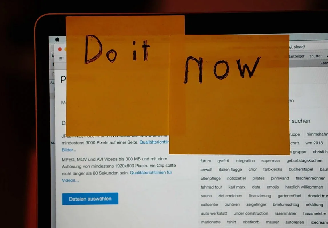 Laptop screen with yellow sticky notes that read Do it now